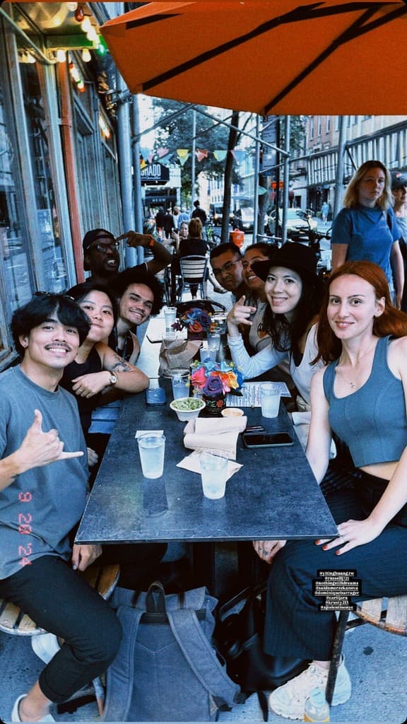 Friends gathered around a table at an outdoor cafe