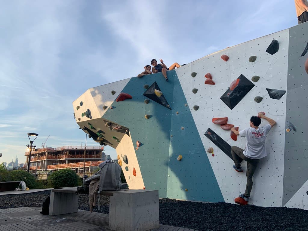 Climbing an outdoor bouldering wall